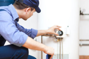 safety technician adjusting a water heater